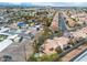 Aerial view of a well-planned community showcasing numerous homes with pools, palm trees, and modern landscaping at 5050 Secret Rock St, Las Vegas, NV 89122