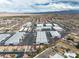 Expansive aerial view showcases warehouses in a residential neighborhood with mountain views at 5050 Secret Rock St, Las Vegas, NV 89122