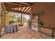 Inviting back patio with stone floors, wood beams, and a seating area at 5050 Secret Rock St, Las Vegas, NV 89122