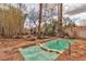 Backyard with tiled pool and spa surrounded by natural stone landscaping and desert foliage at 5050 Secret Rock St, Las Vegas, NV 89122