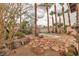 Backyard oasis featuring a small pool, desert landscaping and mature trees at 5050 Secret Rock St, Las Vegas, NV 89122