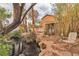 Scenic backyard features a pond, tropical foliage, and a cozy seating area at 5050 Secret Rock St, Las Vegas, NV 89122