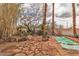 Backyard featuring mature landscaping, stone pathways and private in ground pool with waterfall at 5050 Secret Rock St, Las Vegas, NV 89122