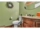 Charming powder room featuring a granite vanity top and decorative fixtures at 5050 Secret Rock St, Las Vegas, NV 89122