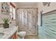 Bathroom features a marble vanity, new toilet, and a decorative shower curtain at 5050 Secret Rock St, Las Vegas, NV 89122