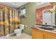 Bathroom features a vanity with a black granite countertop and a decorative shower curtain at 5050 Secret Rock St, Las Vegas, NV 89122