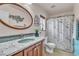 Updated bathroom features a marble vanity, new toilet, and a decorative shower curtain at 5050 Secret Rock St, Las Vegas, NV 89122