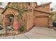 Inviting two-story home featuring a one car attached garage and well-manicured landscaping at 5050 Secret Rock St, Las Vegas, NV 89122