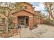 Charming two-story home featuring a covered porch, desert landscaping and a tile roof at 5050 Secret Rock St, Las Vegas, NV 89122