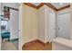 Hallway with wood floors and baseboards leads to white doors and rooms at 5050 Secret Rock St, Las Vegas, NV 89122