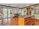 Kitchen with island, breakfast bar, sliding door access, and seamless flow to other rooms at 5050 Secret Rock St, Las Vegas, NV 89122