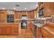 Classic kitchen with wooden cabinets, granite counters, stainless steel appliances, and functional island at 5050 Secret Rock St, Las Vegas, NV 89122