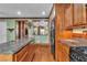Gourmet kitchen featuring granite countertops, wood cabinets, and stainless steel appliances at 5050 Secret Rock St, Las Vegas, NV 89122