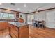 Spacious kitchen featuring granite countertops, wood cabinets, and an island with breakfast bar at 5050 Secret Rock St, Las Vegas, NV 89122