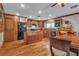 Spacious kitchen and dining area featuring wood cabinets, granite countertops, and modern appliances at 5050 Secret Rock St, Las Vegas, NV 89122