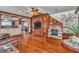 Open-concept living room boasts hardwood floors, a stone fireplace, and elegant built-in cabinetry at 5050 Secret Rock St, Las Vegas, NV 89122