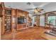 Open living area featuring a stone fireplace and custom wood entertainment center with built-in shelving at 5050 Secret Rock St, Las Vegas, NV 89122