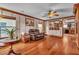 Cozy living room featuring hardwood floors, a ceiling fan, and access to the kitchen at 5050 Secret Rock St, Las Vegas, NV 89122