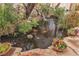 Backyard pond featuring a waterfall, fountain, rock border, and colorful koi fish at 5050 Secret Rock St, Las Vegas, NV 89122