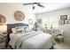 This bedroom has a ceiling fan and window with shutter-style blinds at 5317 Clover Blossom Ct, North Las Vegas, NV 89031