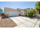 Charming single-story home boasts a well-maintained lawn, two car garage, and inviting curb appeal at 5317 Clover Blossom Ct, North Las Vegas, NV 89031