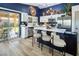 Stylish kitchen with modern island, stainless steel appliances, bar seating, and plenty of natural light at 5317 Clover Blossom Ct, North Las Vegas, NV 89031
