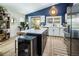 Modern kitchen featuring granite counters, stainless steel appliances, and a built-in wine cooler at 5317 Clover Blossom Ct, North Las Vegas, NV 89031