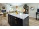 Open-concept design with a kitchen island, stainless steel appliances, and seamless flow into the living area at 5317 Clover Blossom Ct, North Las Vegas, NV 89031