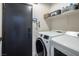 This laundry room features a modern washer and dryer at 5317 Clover Blossom Ct, North Las Vegas, NV 89031