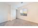 Bedroom featuring a closet, carpet, and a window offering natural light and neighborhood views at 5745 Becklow Gardens Ave, Las Vegas, NV 89141