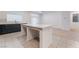 Open-concept kitchen with a large center island, dark cabinetry, and stainless steel appliances with tile floors at 5745 Becklow Gardens Ave, Las Vegas, NV 89141