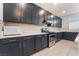 Well-equipped kitchen featuring dark cabinetry, stainless steel appliances, and ample counter space at 5745 Becklow Gardens Ave, Las Vegas, NV 89141