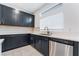 Modern kitchen with dark cabinetry, stainless steel appliances, and ample counter space for cooking at 5745 Becklow Gardens Ave, Las Vegas, NV 89141