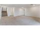 Spacious living area with neutral carpet, white walls, and access to stairs and other rooms at 5745 Becklow Gardens Ave, Las Vegas, NV 89141