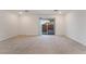 Spacious carpeted room featuring sliding glass door to the backyard, white walls, and recessed lighting at 5745 Becklow Gardens Ave, Las Vegas, NV 89141