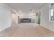 Open-concept living room with modern fireplace, neutral carpet, and access to a balcony, perfect for entertaining at 5745 Becklow Gardens Ave, Las Vegas, NV 89141
