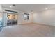 Bright living room featuring a modern fireplace, neutral carpet, and large sliding glass doors at 5745 Becklow Gardens Ave, Las Vegas, NV 89141