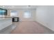 Bright, carpeted living area features natural light and flows into the kitchen area with modern finishes at 5745 Becklow Gardens Ave, Las Vegas, NV 89141