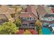 Aerial shot showcases the home's tiled roof, yard with greenery, and nearby pool at 605 Bachelor Button St, Las Vegas, NV 89138
