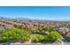 Aerial view of a community featuring green space, lush trees, and stunning mountain views at 605 Bachelor Button St, Las Vegas, NV 89138