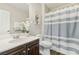 Bathroom with a vanity, framed art and a blue and white striped shower curtain at 605 Bachelor Button St, Las Vegas, NV 89138
