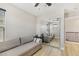 A cozy bedroom featuring a sofa, mirrored closet, and light hardwood flooring at 605 Bachelor Button St, Las Vegas, NV 89138