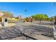 Gated entrance to a community with desert landscaping and mature trees at 605 Bachelor Button St, Las Vegas, NV 89138