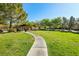 Walking path through a park area with benches, pavilion, and ample green space at 605 Bachelor Button St, Las Vegas, NV 89138