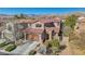 Beautiful two-story home showcasing a tile roof, stone accents, well-manicured landscaping, and mountain views at 605 Bachelor Button St, Las Vegas, NV 89138