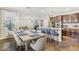 Open concept kitchen with granite counters, stainless steel appliances, island seating, and adjacent dining area at 605 Bachelor Button St, Las Vegas, NV 89138