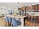 Modern kitchen featuring a spacious island with seating, stainless steel appliances, and dark wood cabinets at 605 Bachelor Button St, Las Vegas, NV 89138