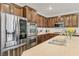 Close up of gourmet kitchen with stainless steel refrigerator and oven, and stone countertops at 605 Bachelor Button St, Las Vegas, NV 89138