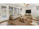 Inviting living room with a neutral color palette, multiple windows, and comfortable seating arrangement at 605 Bachelor Button St, Las Vegas, NV 89138