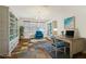 Bright office space with custom built-ins, a desk, and a comfortable blue accent chair at 605 Bachelor Button St, Las Vegas, NV 89138